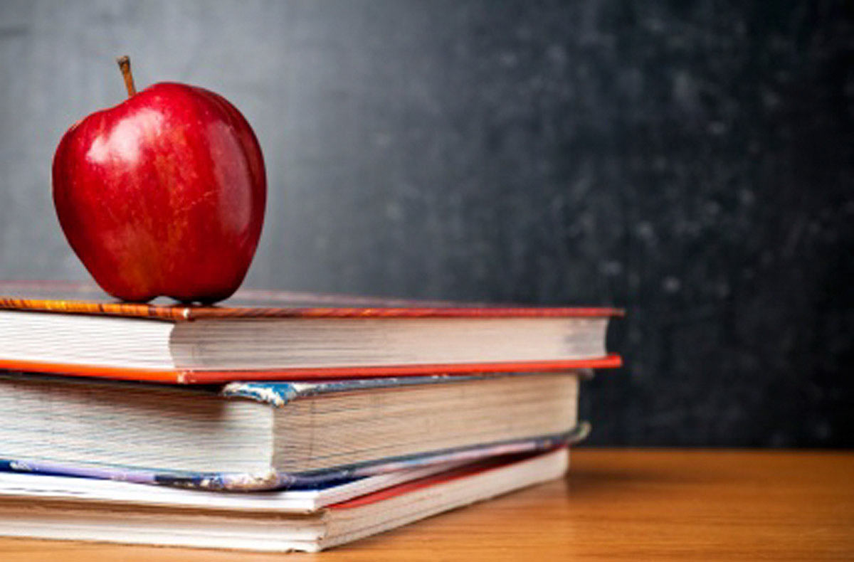 Picture of an apple on top of a stack of books