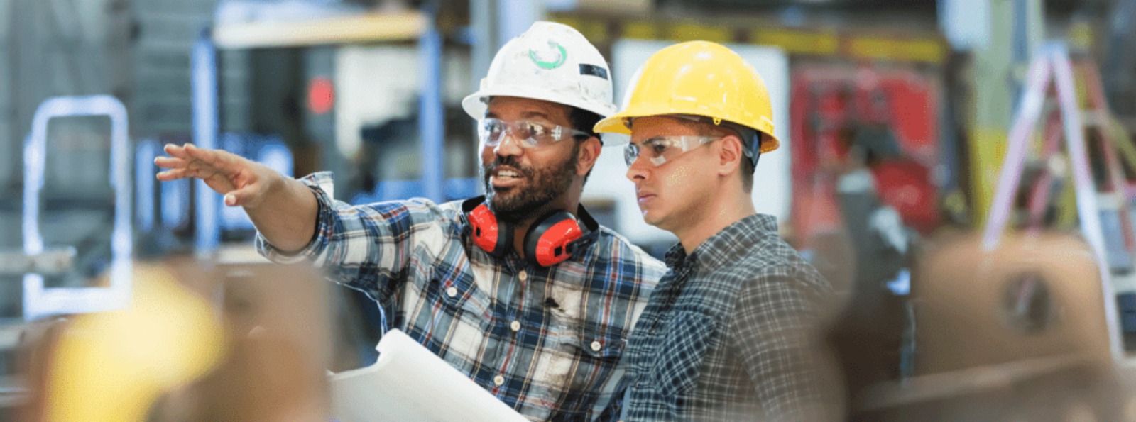 two people working inside a factory