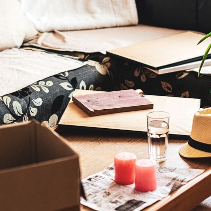 living room table with a hat, glass of water and candles