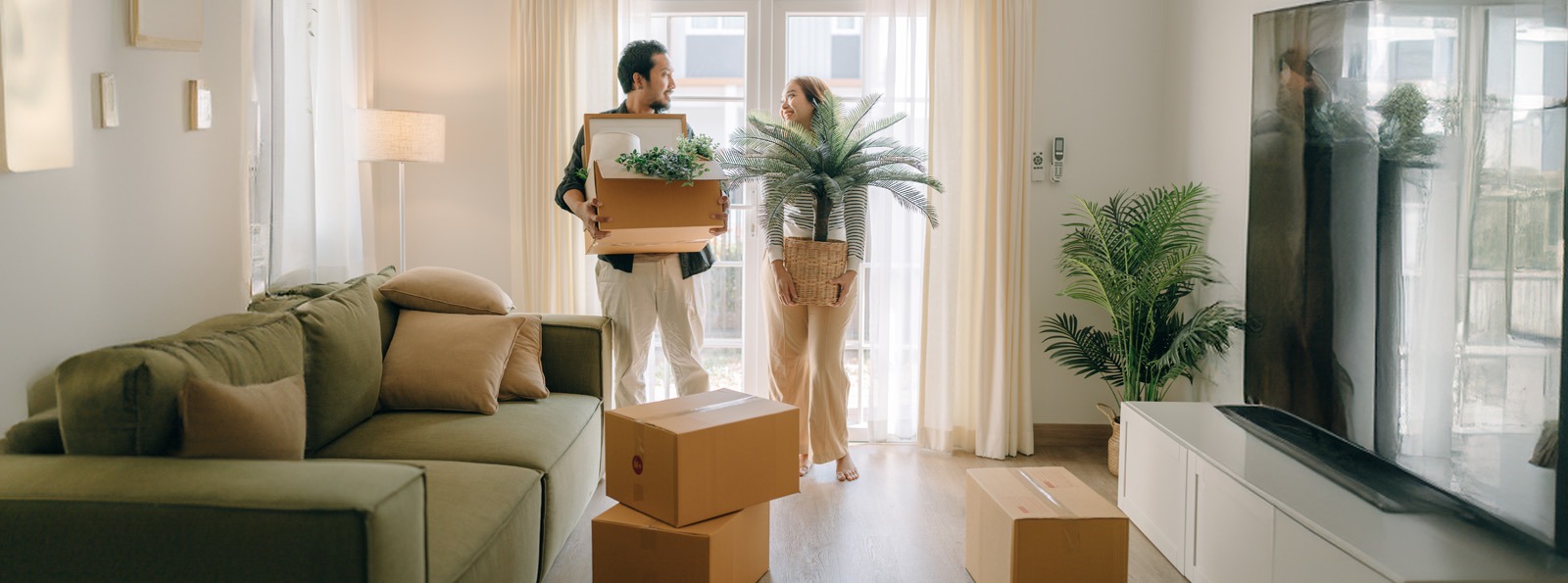 a couple placing items in their new home