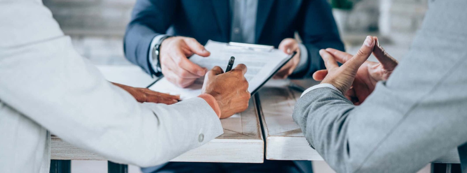 a couple reviewing documents with an advisor