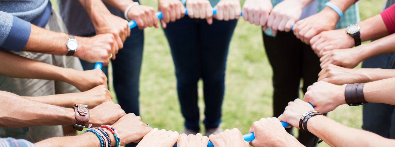 people with their hands on a hoop