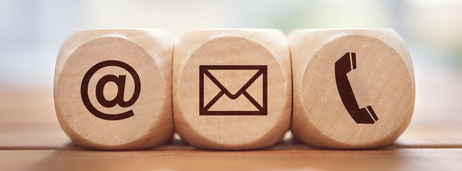 small wooden blocks with an "at" sign, envelope and telephone receiver icons
